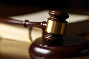 Wooden judge's gavel on a table, symbolizing justice and authority. photo