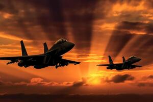Two airplanes flying in the colorful sky during sunset. photo