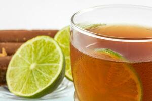 Cold sugarcane water with lemon on white background. Aguapanela photo