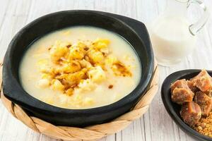 Traditional Colombian corn mazamorra served in black ceramic dish photo