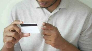 Thoughtful young man hand hold a credit card video