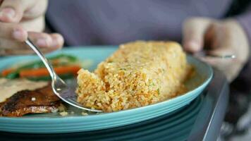 eating cooked rice with a spoon close up video