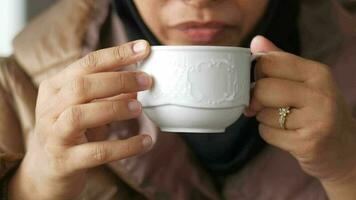 Close up of woman's hand holding coffee mug video