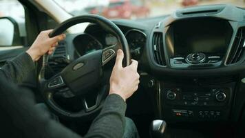 Man driving in innovative automated car using self-parking autopilot for parking on parking lot video