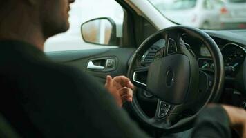 Man driving in innovative automated car using self-parking autopilot for parking on parking lot video