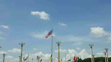 Several flagpoles with the Malaysian flag attached to them. The flag flutters in the wind. Located in Dataran Putra Jaya in front of the Pink Putra Jaya Mosque video