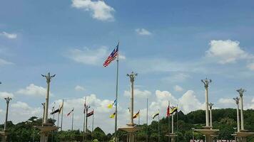 Several flagpoles with the Malaysian flag attached to them. The flag flutters in the wind. Located in Dataran Putra Jaya in front of the Pink Putra Jaya Mosque video