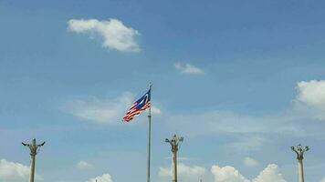 Several flagpoles with the Malaysian flag attached to them. The flag flutters in the wind. Located in Dataran Putra Jaya in front of the Pink Putra Jaya Mosque video