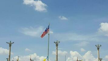 Several flagpoles with the Malaysian flag attached to them. The flag flutters in the wind. Located in Dataran Putra Jaya in front of the Pink Putra Jaya Mosque video