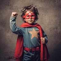 Child pretending to be a superhero with proper costume with hands up . photo