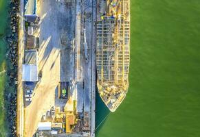 A part of a tanker of the city port. Aerial top view from a drone. Concept export ship photo