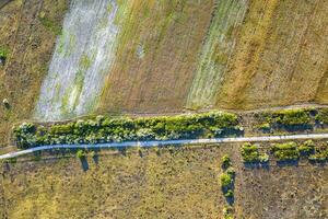 Aerial view from drone to different fields and road. Top view photo