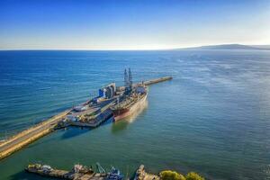 A tanker of the city port. Aerial view from a drone. Concept export ship photo