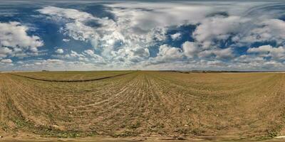 spherical 360 hdri panorama among farming field with clouds on blue sky in equirectangular seamless projection, use as sky replacement in drone panoramas, game development as sky dome or VR content photo