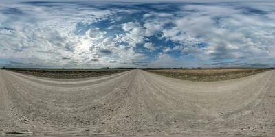 spherical 360 hdri panorama on gravel road with clouds on overcast sky in equirectangular seamless projection, use as sky replacement in drone panoramas, game development as sky dome or VR content photo