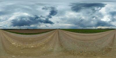 evening 360 hdri panorama on gravel road with clouds on overcast rain sky before storm in equirectangular spherical seamless projection, use as sky replacement in drone panoramas, game development photo