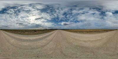 spherical 360 hdri panorama on gravel road with clouds on overcast sky in equirectangular seamless projection, use as sky replacement in drone panoramas, game development as sky dome or VR content photo