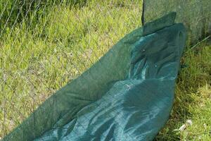 Installation of a protective mesh on the fence photo