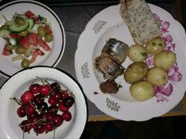 Mediterranean lunch with fish, salad and potatoes photo