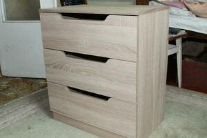 Assembling dresser furniture for storing clothes photo