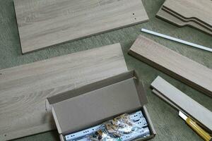 Assembling dresser furniture for storing clothes photo