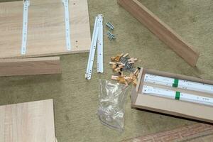 Assembling dresser furniture for storing clothes photo