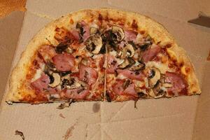 Pizza with bacon, cheese and mushrooms photo