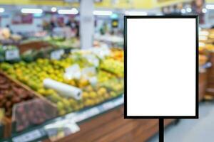 Blank price board with fresh food in supermarket abstract blurred background photo