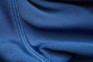 Blue sports clothing fabric football shirt jersey texture with stitches photo