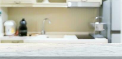 white marble stone counter top with blurred kitchen background photo