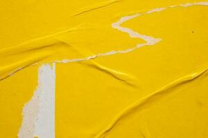 Old grunge ripped torn yellow paper poster surface texture background photo