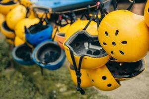 Yellow protective durable plastic helmets for rafting boating - personal protective equipment - active sports photo