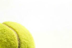 Fragment of yellow tennis ball close up on white isolated background - tennis background photo