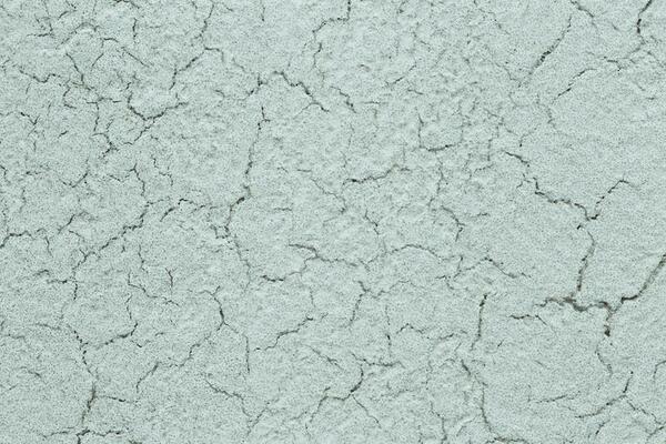 Background with cracks on a light wall - raw plaster or old canvas