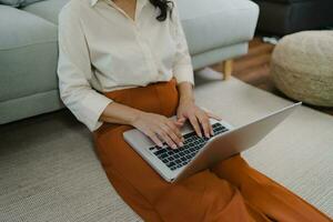 Working by using a laptop computer on wooden table. Hands typing on a keyboard.technology e-commerce concept photo