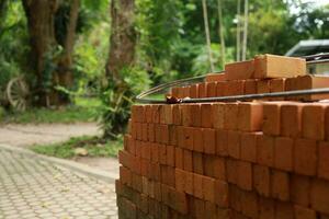 Pallet a red brick building material stack of new red bricks for construction. photo