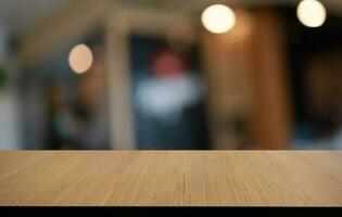 Wood table top in front of abstract blurred background. Empty wooden table space for text marketing promotion. blank wood table surface copy space photo