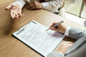 Examiner reading a resume during job interview at office Business and human resources concept photo