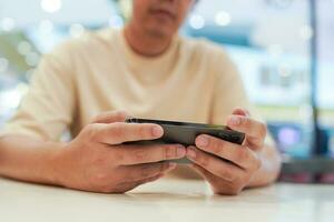 Man playing game on mobile phone. photo