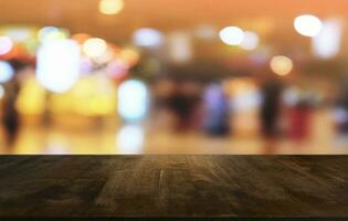 Empty dark wooden table in front of abstract blurred bokeh background of restaurant . can be used for display or montage your products.Mock up for space. photo