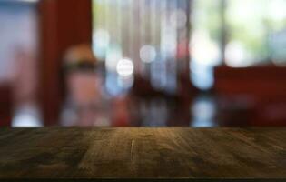 Empty dark wooden table in front of abstract blurred bokeh background of restaurant . can be used for display or montage your products.Mock up for space. photo