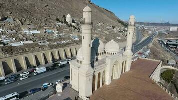 aerial view of a magnificent mosque by the road and the sea video