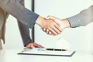 Real estate agent handshake. Business partnership meeting concept. and home insurance. photo