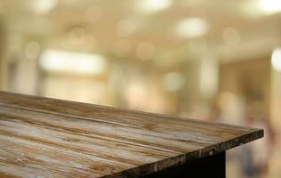 Empty wooden table in front of abstract blurred background of coffee shop . can be used for display or montage your products.Mock up for display of product photo