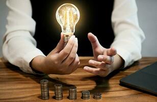 saving coins idea with light bulb for investment Concept idea and innovation. photo