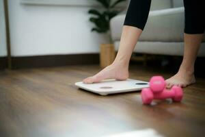 Fat diet and scale feet standing on electronic scales for weight control. Measurement instrument in kilogram for a diet control photo