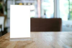 Menu frame standing on wood table in Bar restaurant cafe. space for text marketing promotion. photo