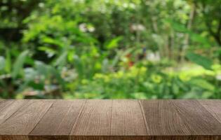 Empty wood table top and blur of out door garden background Empty wooden table space for text marketing promotion. blank wood table copy space for background photo