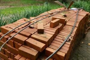 Pallet a red brick building material stack of new red bricks for construction. photo