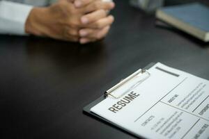 Examiner reading a resume during job interview at office Business and human resources concept. photo